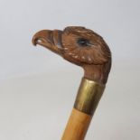 A walking stick, the carved wooden handle in the form of an eagle, with glass eyes, 91 cm