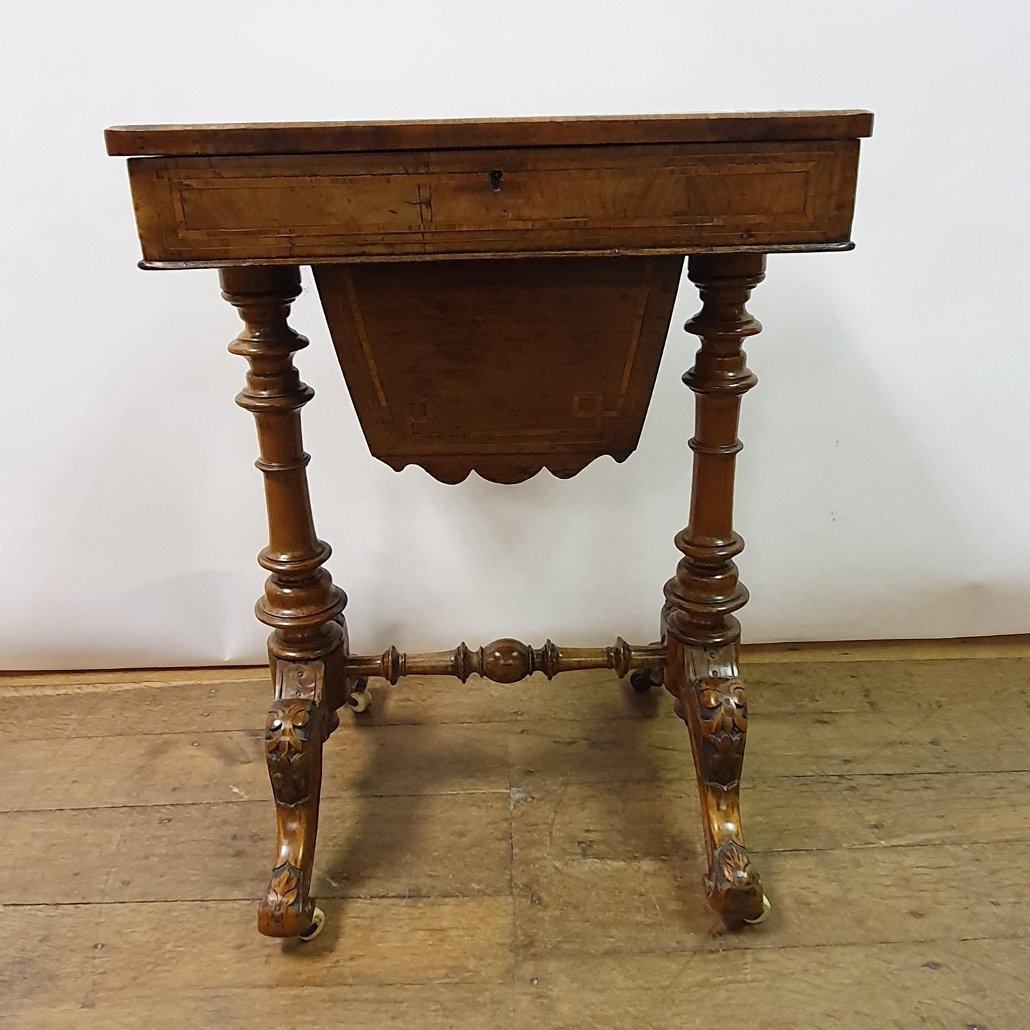A 19th century walnut workbox, on a column supports and splay legs united by stretcher, 54 cm wide - Image 5 of 5