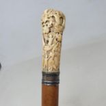 A late 17th/early 18th century walking stick, the ivory carved various figures, 94 cm