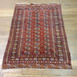 An Afghan red ground carpet, 285 cm x 180 cm, and another 187 cm x 130 cm