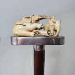 A walking stick, the ivory handle carved in the form of two elephants, on hardwood shaft, 93 cm