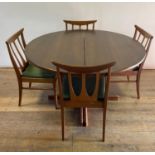 A G-Plan teak extending dining table, 120 cm diameter, with two extra leaves, four dining chairs,