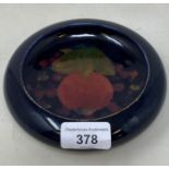 A Moorcroft pottery pomegranate pattern dish, 15 cm diameter