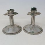 A pair of early 20th century Arts and Crafts style silver plated candlesticks, 13 cm high