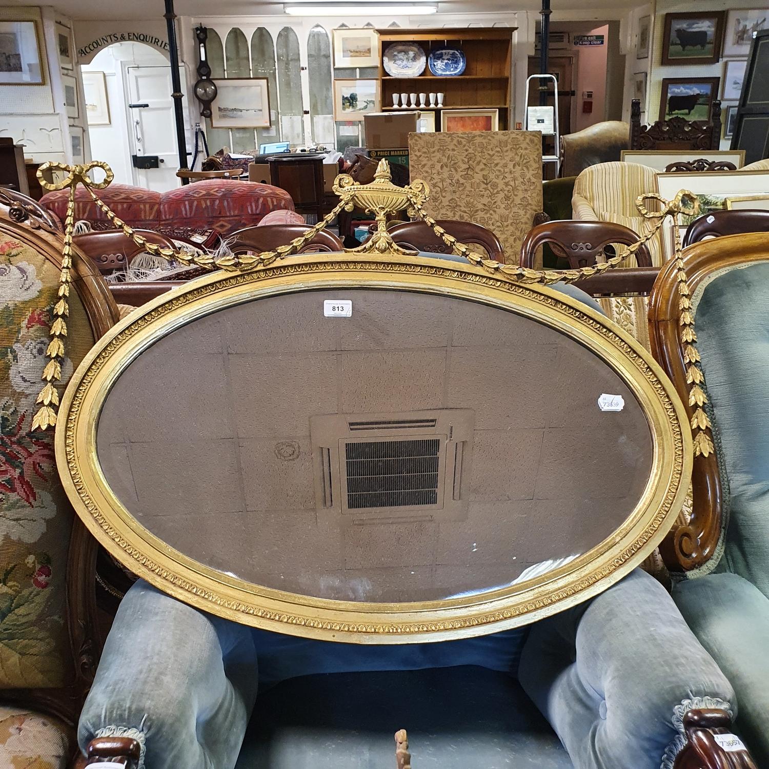 An oval gilt wall mirror, with a vase finial, 90 cm wide, and another mirror (2)