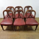 A set of six 19th century mahogany hoop back dining chairs, with padded seats on turned tapering