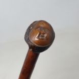 A walking stick, with coquille nut handle carved in the form of an oriental male head, 92 cm