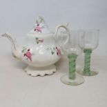 A 19th century porcelain teapot, a pair of wine glasses with green and white air twist stems, and