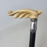 A walking stick, with a carved ivory handle, silver collar on ebonised shaft, 86 cm