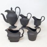 A Wedgwood black Jasperware coffee pot, 20 cm high, and four cream jugs (5)