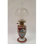An oil lamp, with acid etched shade, on a clear glass base, decorated birds and flowers, 58 cm high