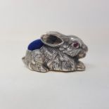 A modern silver coloured metal rabbit pincushion, stamped 925
