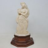 An early 20th century Indian carved ivory figure, of a woman holding a vase, on a wooden base, 28 cm