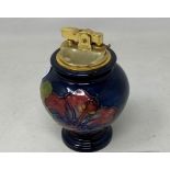A Moorcroft pottery hibiscus pattern table lighter, 11 cm high
