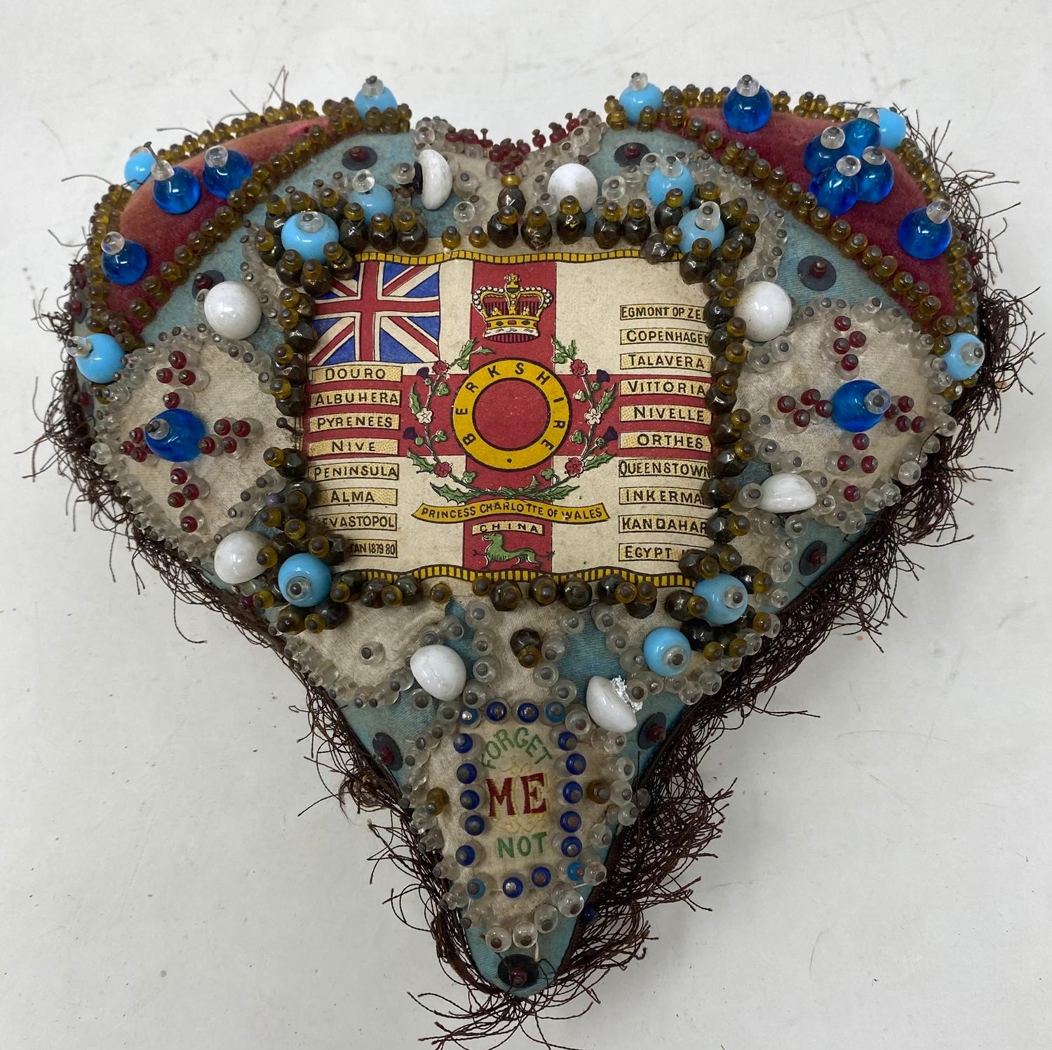 An early 20th century sweetheart bead pincushion, 20 cm wide