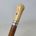 A walking stick, with carved ivory handle, Malacca shaft, 90 cm