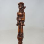 A late 19th/early 20th century folk art walking stick, the carved handle in the form of a Breton