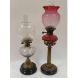 An oil lamp, with acid etched cranberry shade, with cranberry well, on brass base, 73 cm, and an oil