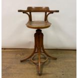 A mid-20th century bentwood adjustable high chair