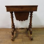 A 19th century walnut workbox, on a column supports and splay legs united by stretcher, 54 cm wide