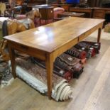 A French cherry wood kitchen table, with three frieze drawers, on tapering square legs, 200 x 85 cm