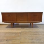 A teak dining room suite, comprising a sideboard, 185 cm wide, extending dining table with single