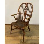 An elm Windsor style chair, with a wheel back, 104 cm high
