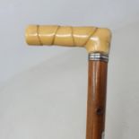 A walking stick, with a carved ivory faux bamboo handle and a silver collar, on Malacca shaft, 89 cm