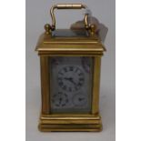 A modern brass carriage clock, inset with painted porcelain panels, 10 cm high
