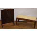 An Arts and Craft style oak stool, 83 cm wide, and a carved oak firescreen, 50 cm wide (2)