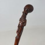 A 19th century folk art walking stick, the carved handle in the form of a man with a moustache, with