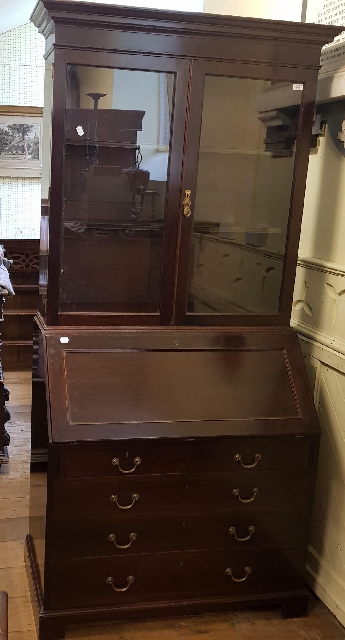 An early 20th century mahogany bureau bookcase, the top with two glazed doors, above fall front with