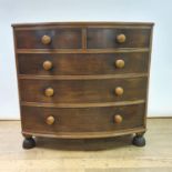 A 19th century mahogany bow front chest, having two short and three long drawers, on turned feet,