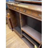 An oak bookcase, with four drawers, 137 cm wide, and a mahogany shelf (2)