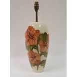 A large Moorcroft pottery hibiscus pattern lamp, of slender ovoid form, cracked, 36 cm high (