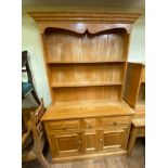 A pine dresser, 117 cm wide, a pine kitchen table, six dining chairs, and an armchair (9)