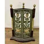 An Arts & Crafts style cast iron corner stick stand, decorated flowers and vases, 43 cm wide
