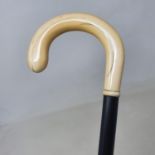 A walking stick, with a carved ivory handle, on ebony shaft, 92 cm