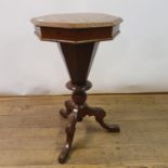A 19th century octagonal workbox, the top inlaid for chess, on column a support and tripod base,