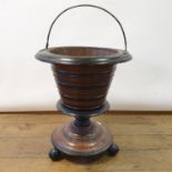A 19th century Dutch mahogany tea bucket, on bun feet, 60 cm high