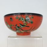 A Chinese red ground bowl, decorated birds, flowers and script, six character mark to base, 14 cm