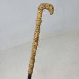 A walking stick, with Chinese carved ivory handle decorated figures and dragons, 84 cm