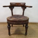 A 19th century mahogany armchair, with leather padded seat, on carved turned tapering legs