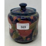 A Moorcroft pottery pomegranate pattern tea caddy and cover, of waisted form, 13 cm high