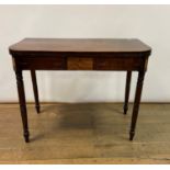 A 19th century mahogany tea table, on turned legs