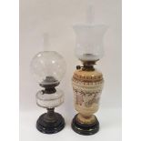 An oil lamp, with acid etched glass shade, a porcelain body decorated stylised flowers, 69 cm, and