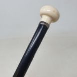 A walking stick, with carved ivory handle, on ebonised shaft, 92 cm