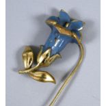 An Art Nouveau yellow metal and enamel pin, in the form of a flower