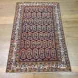 A Persian blue ground rug, main cream border, centre with repeating medallions, 203 cm x 131 cm