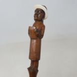 A 19th century folk art walking stick, the handle carved in the form of a preacher with an ivory